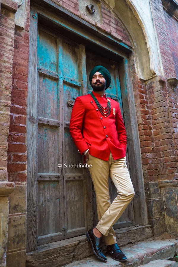 Elegant groom portrait featuring a confident Indian groom standing with his hands folded in a classic wedding pose.