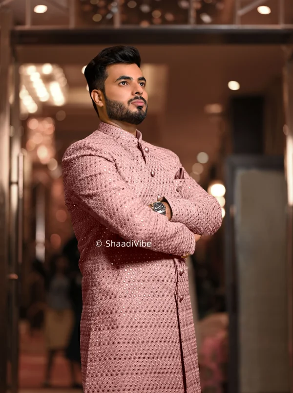 3 Classic Indian groom pose featuring the groom standing confidently in his embroidered wedding sherwani.
