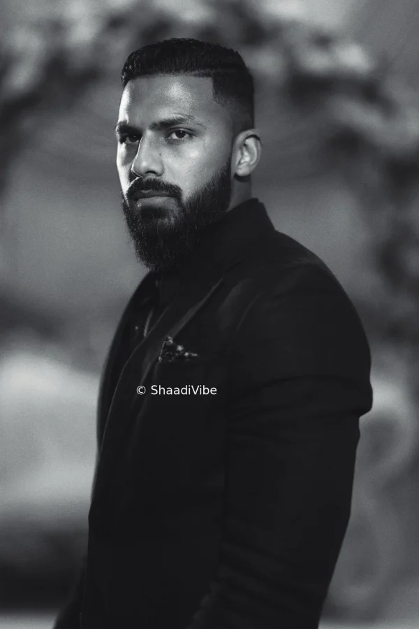 Regal groom portrait featuring an Indian groom wearing a traditional safa and embroidered sherwani.
