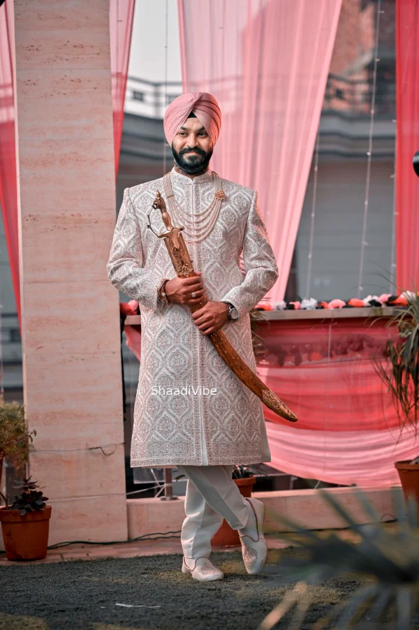 Traditional Indian groom posing with his wedding stole for a classic and elegant sherwani portrait.