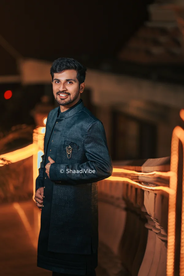 Confident Indian groom portrait featuring a contemporary sherwani and relaxed modern wedding pose.
