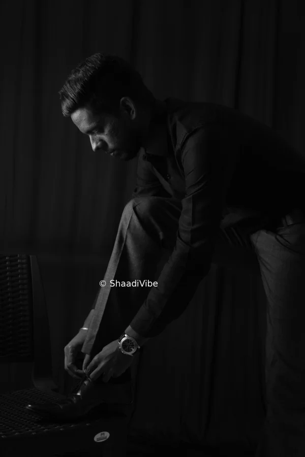Stylish Indian groom posing confidently for a classic wedding day portrait.