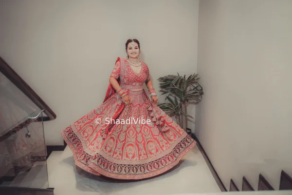Traditional crimson bridal lehenga featuring intricate motifs and rich embroidery for a classic Indian wedding.