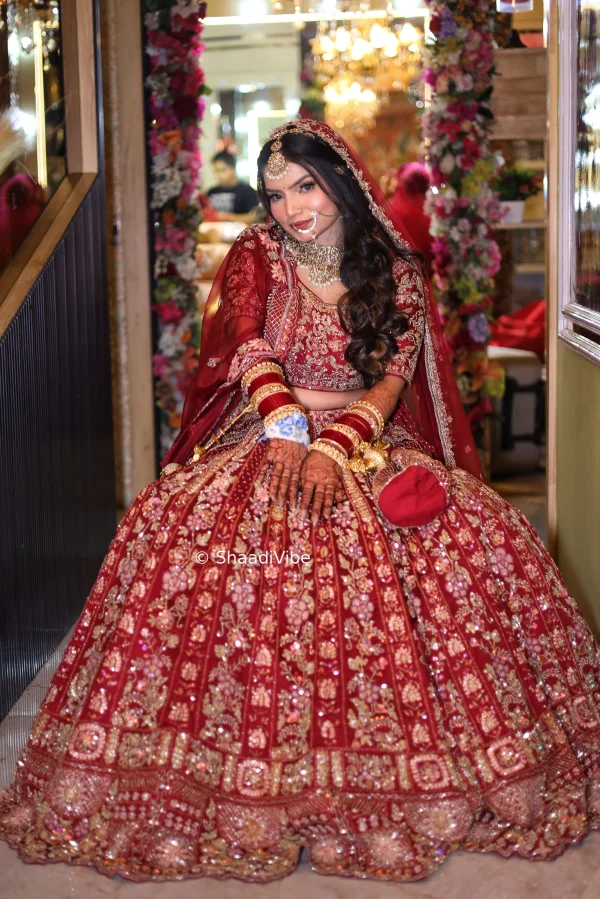 Classic red and gold bridal lehenga combining traditional embroidery with a grand Indian wedding aesthetic.