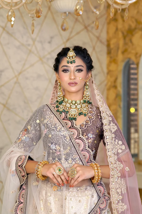 Dusty rose bridal lehenga with delicate embellishments for a refined and romantic contemporary wedding look.