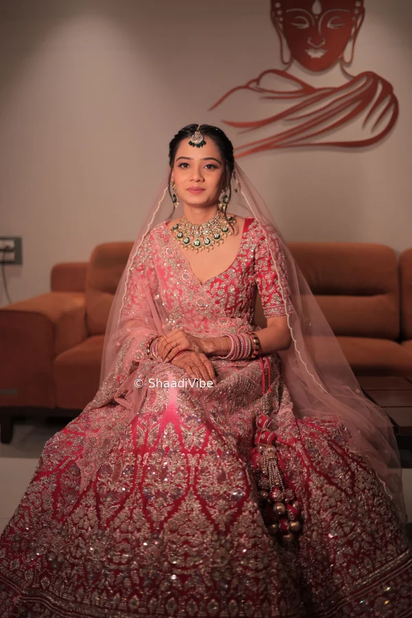 Classic ombre pink bridal lehenga featuring detailed zari work and a traditional dupatta and head dupatta for an elegant wedding outfit.