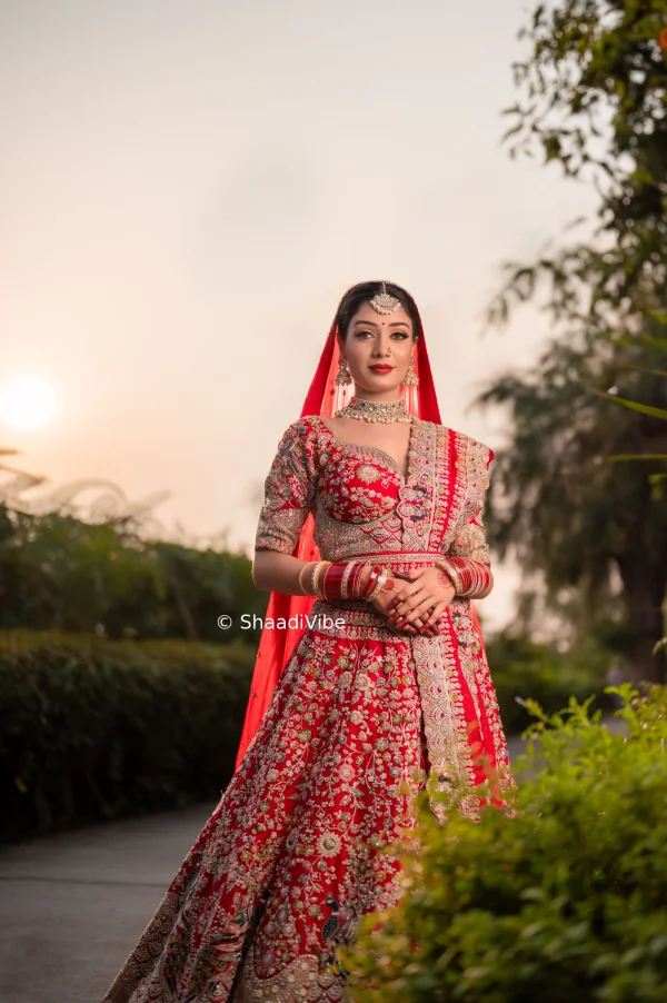 Classic red bridal lehenga featuring intricate embroidery and traditional detailing for a timeless Indian wedding look.