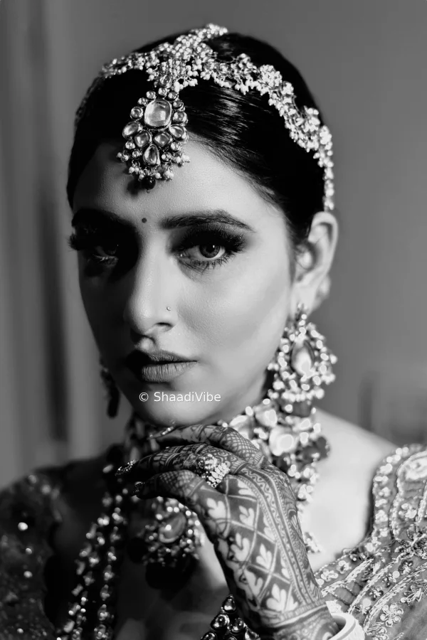 Graceful Indian bride portrait featuring a detailed bridal hairstyle, statement earrings and traditional wedding jewellery.