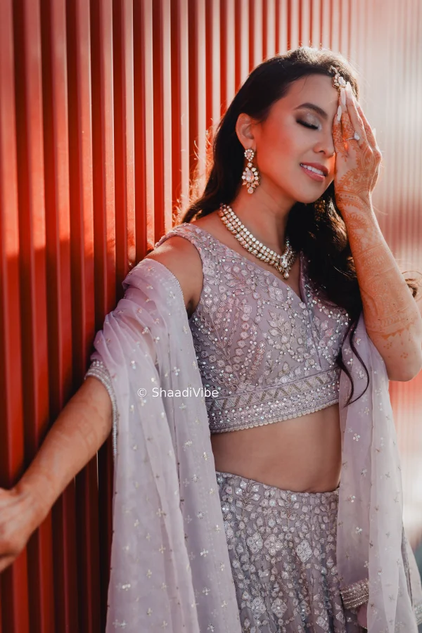 Timeless bridal portrait showcasing an Indian bride in a richly embroidered lehenga with traditional wedding jewellery.