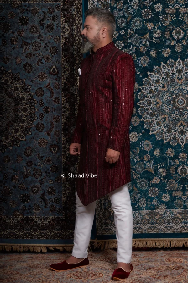 Rich burgundy sherwani with intricate embroidery creating a bold yet classic Indian groom wedding look.
