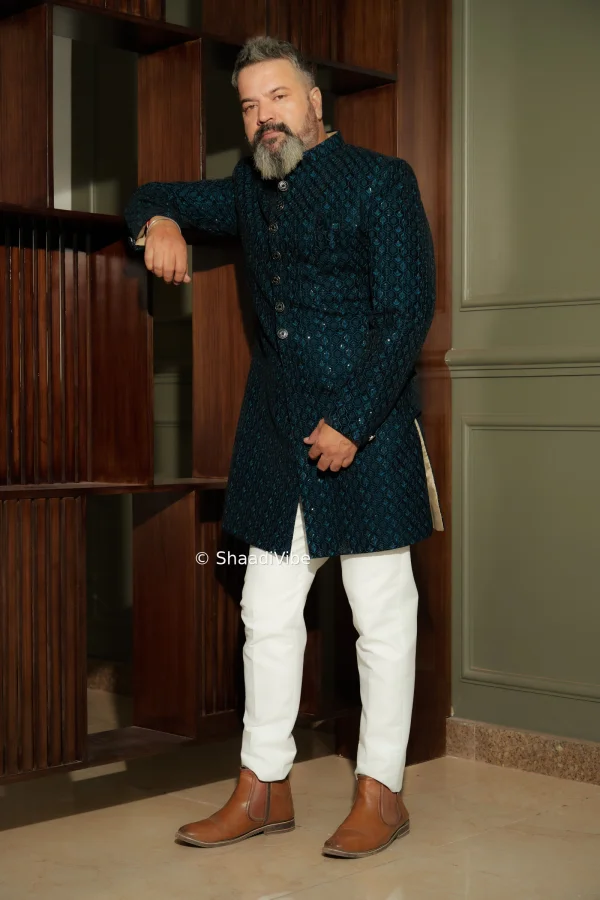 Leaf green self embroidered achkan with contrast bottom.