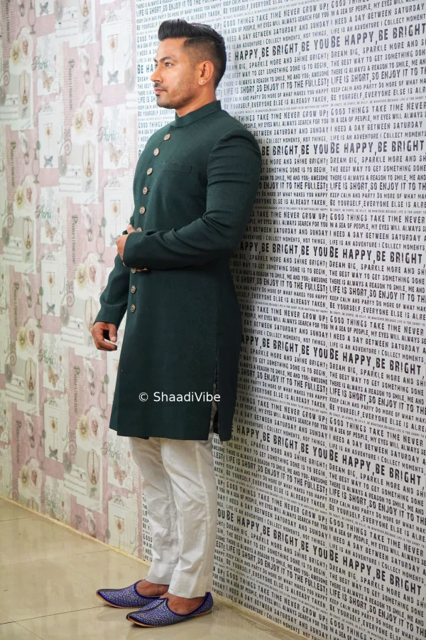 Classic navy green achkan with detailed embroidery for a sophisticated and elegant groom wedding look.
