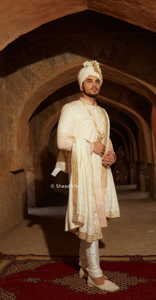 Timeless cream sherwani with tonal embroidery with pink dupatta and a structured fit for a sophisticated wedding day appearance.