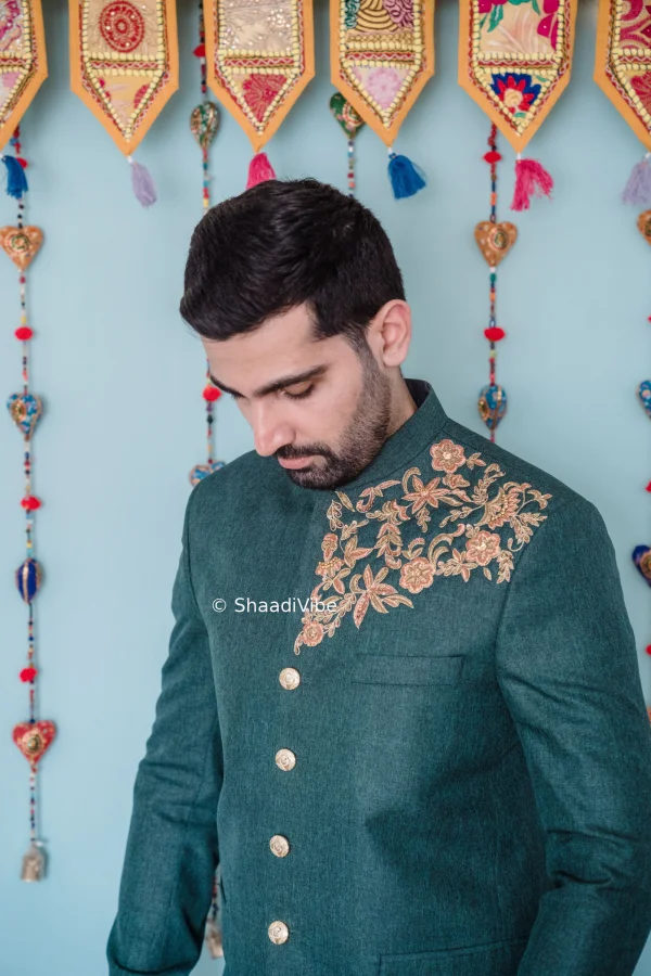 Stylish sage green sherwani with subtle embroidery for a contemporary Indian groom wedding outfit.