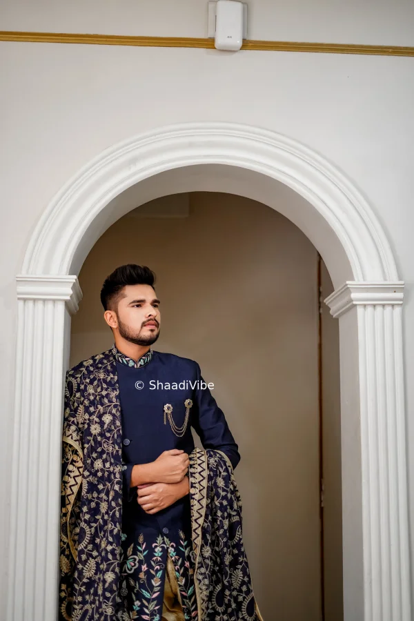 Classic navy blue sherwani with detailed embroidered dupatta for a sophisticated and elegant groom wedding look.