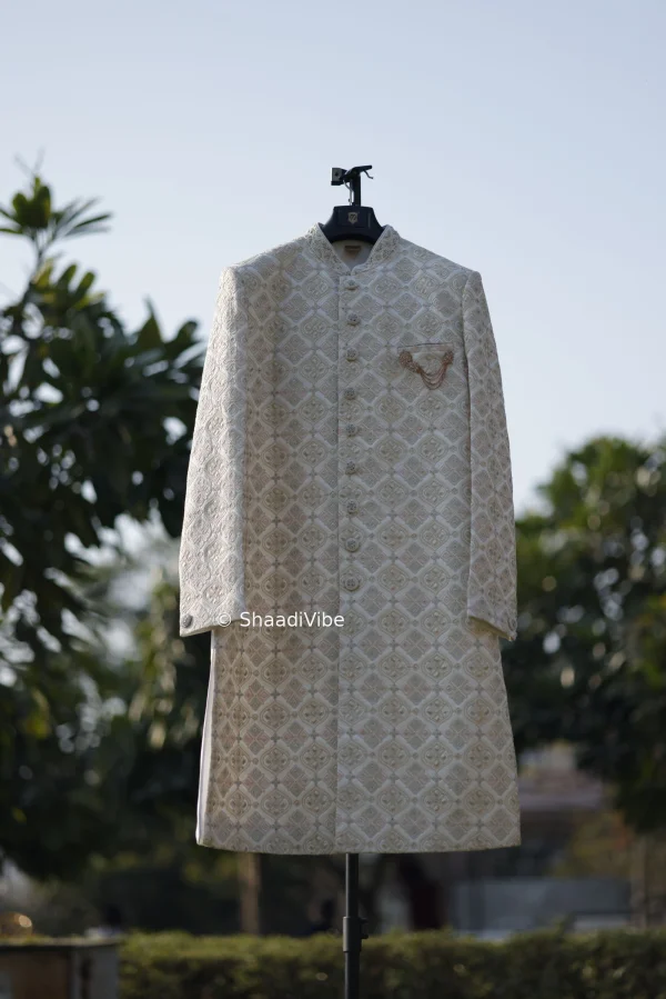 Classic ivory sherwani featuring intricate embroidery for a timeless and sophisticated Indian groom look.