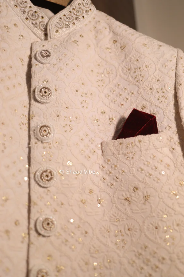 Traditional gold-toned sherwani with intricate embroidery for a regal Indian groom wedding look.