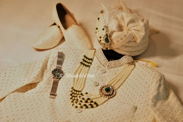 Classic ivory sherwani featuring intricate embroidery for a timeless and sophisticated Indian groom look.