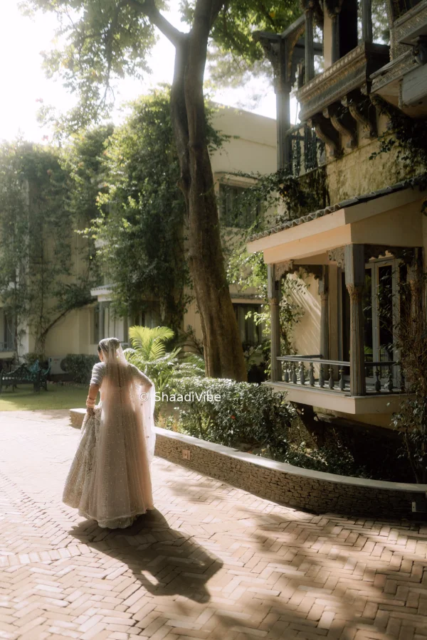 Playful bridal pose featuring the bride lifting her lehenga slightly while walking during her wedding celebrations.