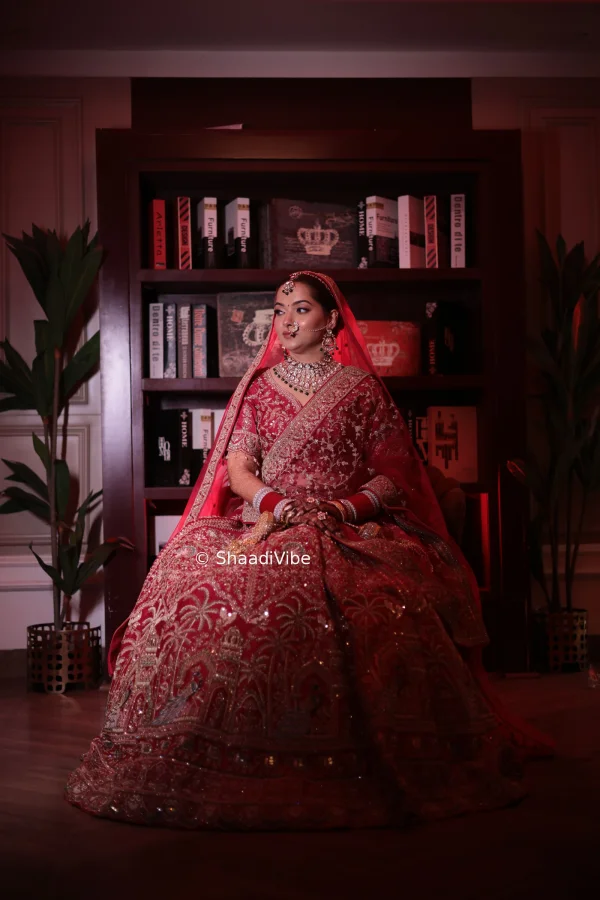 Indian bride posing with one hand gently touching her hair for a natural and effortless bridal photograph.
