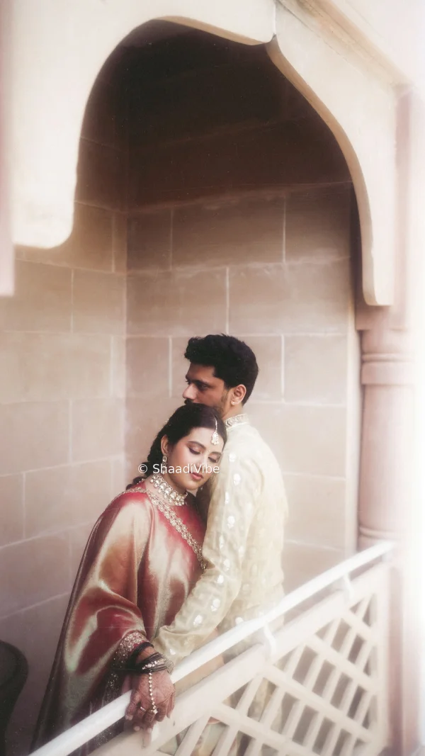 Candid wedding photograph of an Indian couple sharing a relaxed moment together in a beautiful outdoor location.