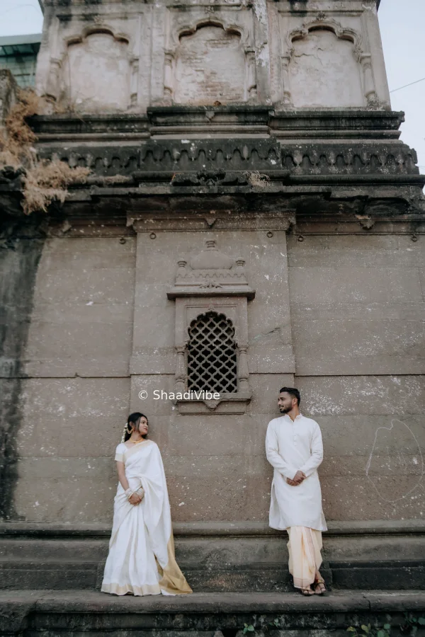 Natural pre-wedding couple pose featuring the bride and groom sitting together and enjoying a quiet moment during their photoshoot.