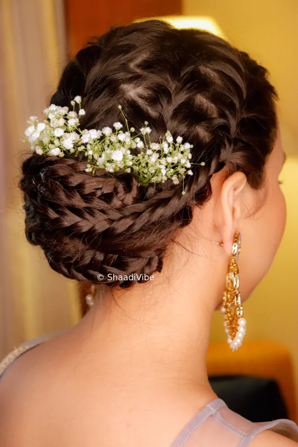 unique braided Bun with gypsy flower makes it elegant and timelss.