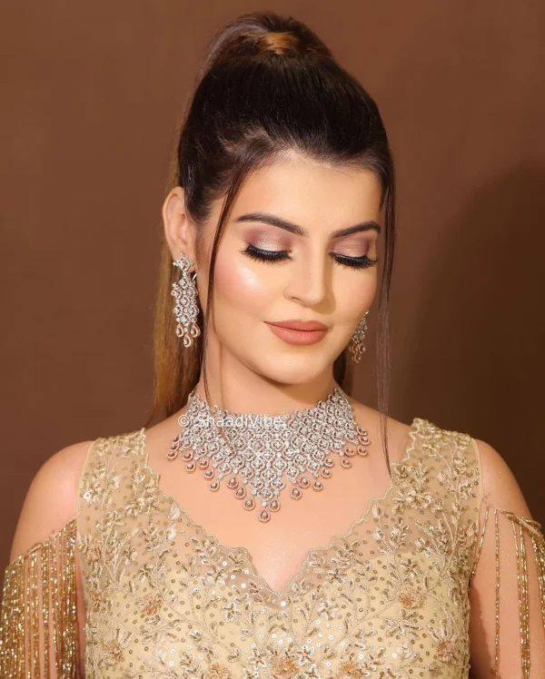 Contemporary bridal ponytail with soft waves and elegant accessories for a modern Indian wedding celebration.