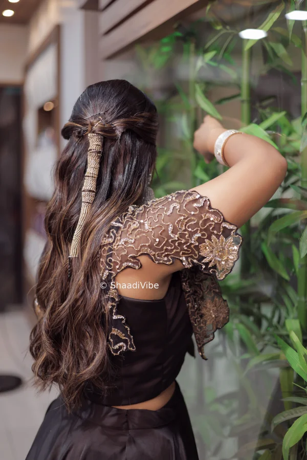 Soft curls with golden hair accessories for sleek look for sangeet which is going perfectly with her outfit.