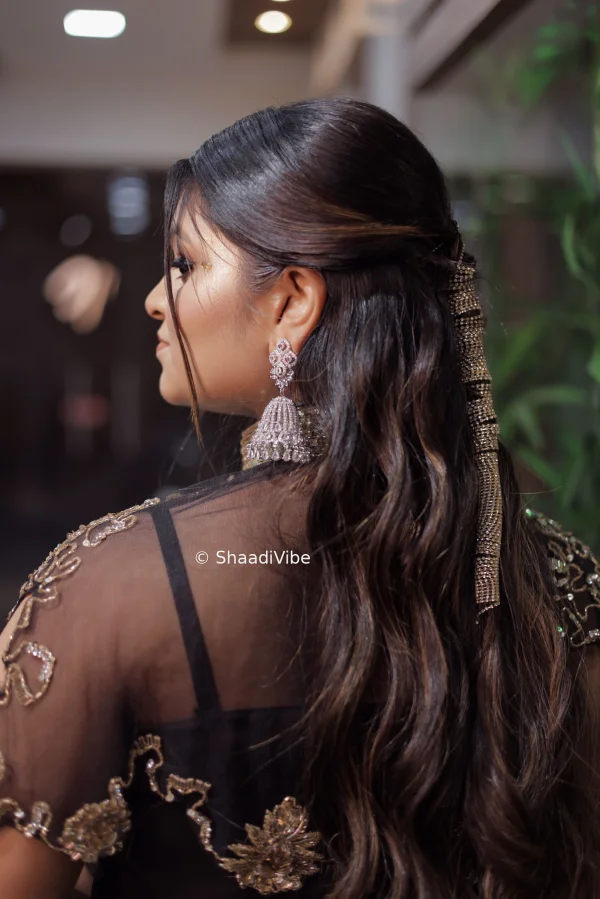 Soft curls with golden hair accessories for sleek look for sangeet.