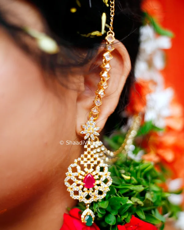 Inidian bridal traditional diamond earrings with red stone in it for her wedding day.