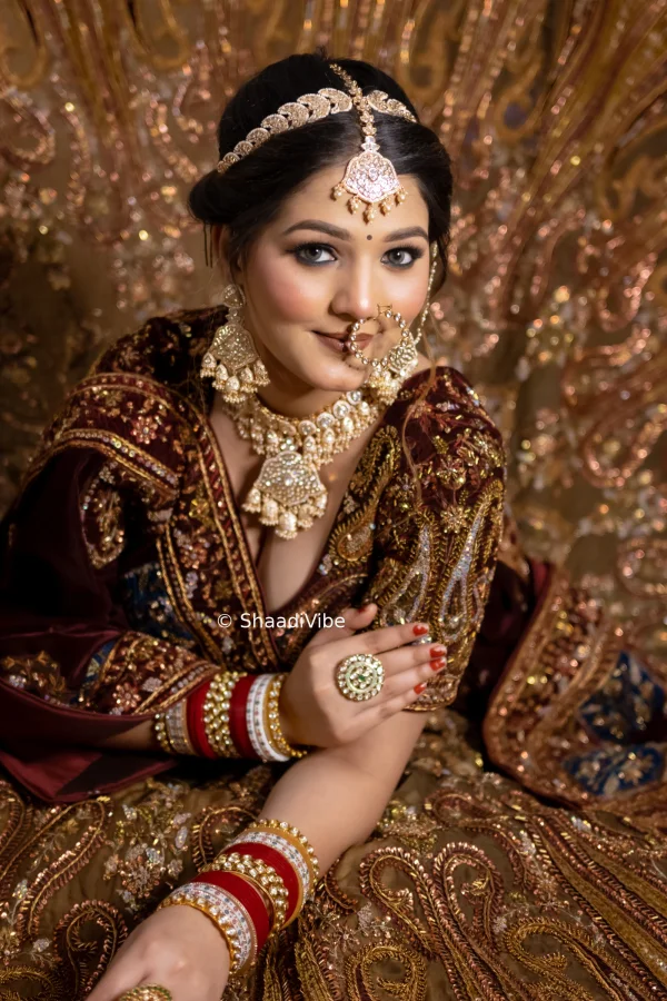 Statement bridal necklace paired with traditional earrings and a maang tikka for a luxurious Indian wedding look.